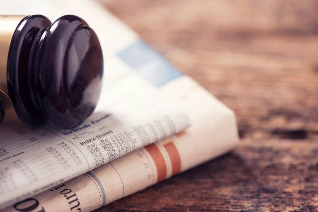 Gavel Resting on Newspaper Scaled