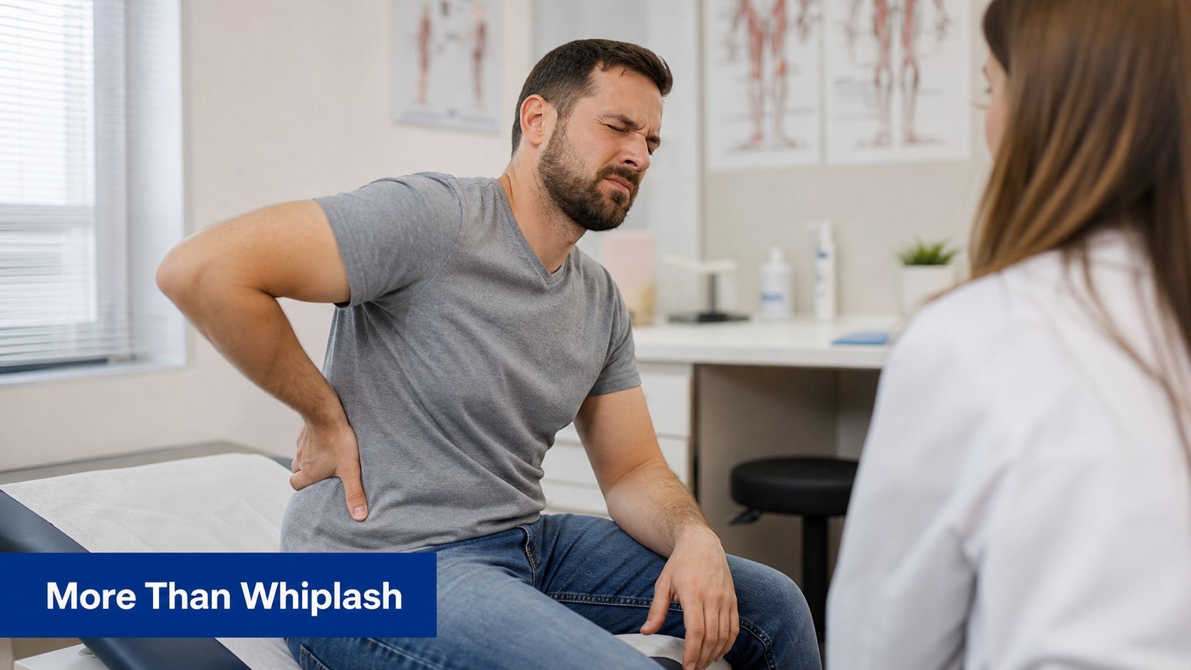 A man experiencing lower back pain consults with a female doctor in a professional medical office setting.